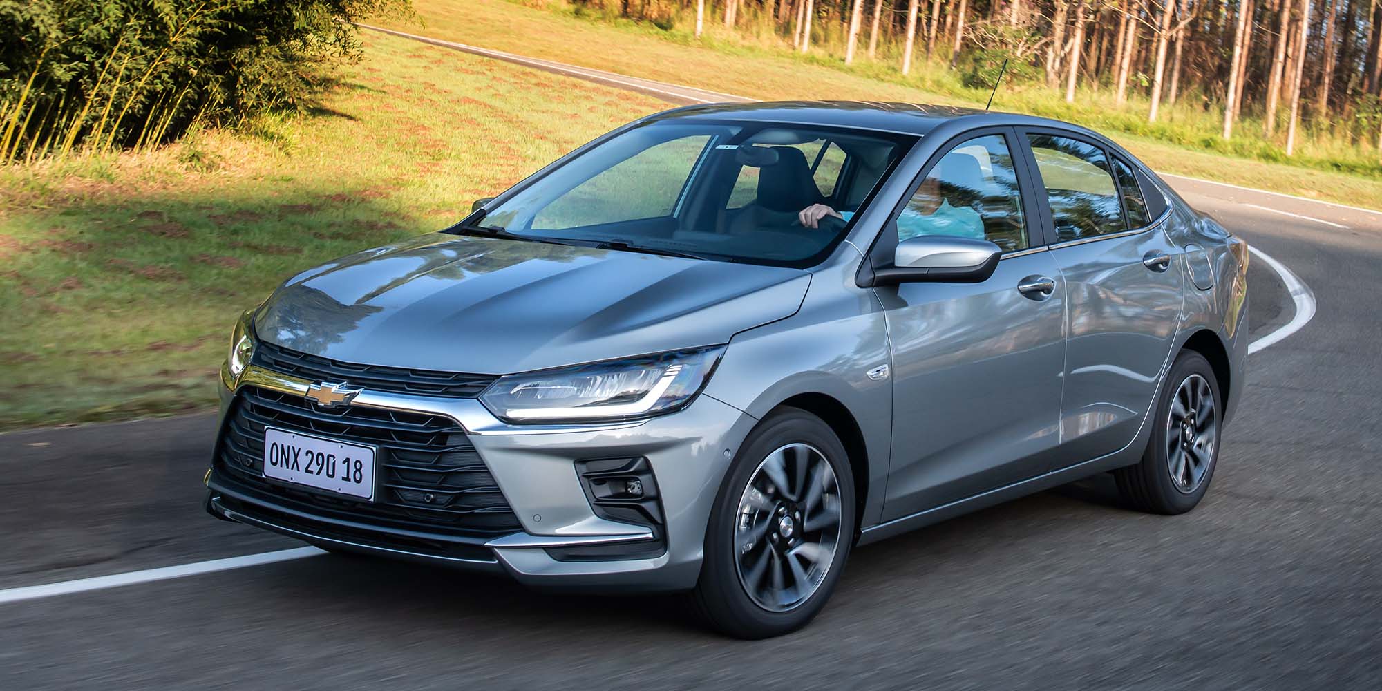 Chevrolet Onix Sedán 2026 color gris en movimiento